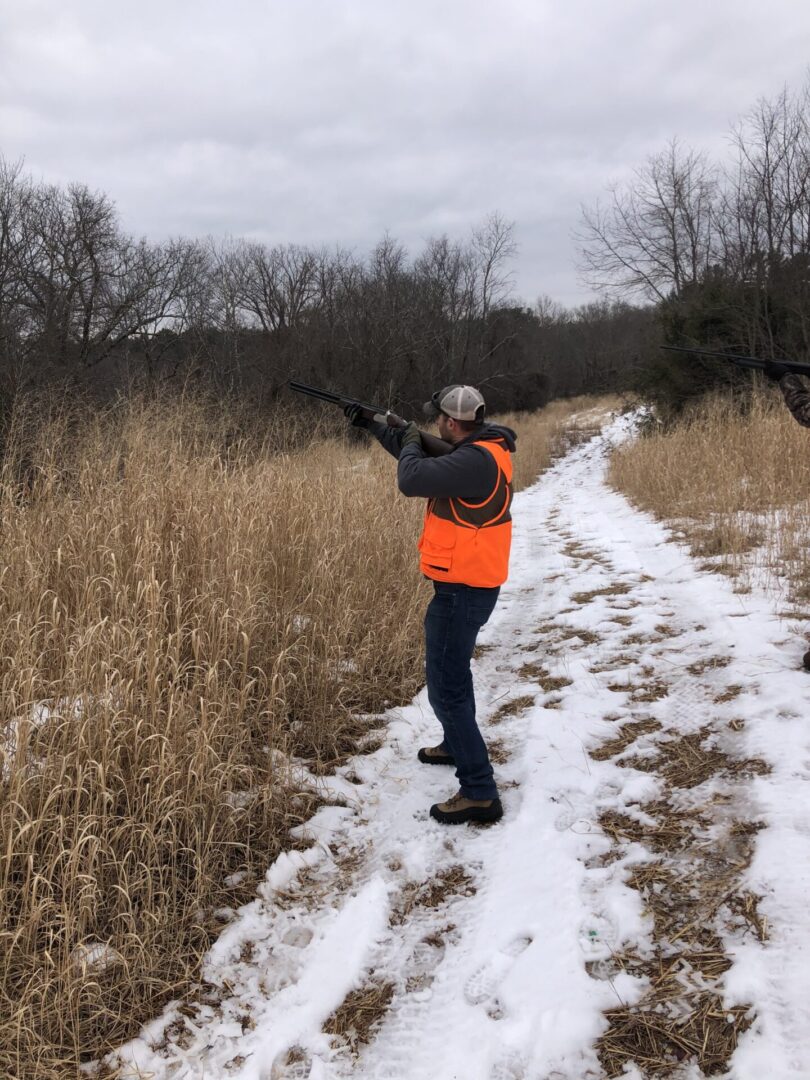 A Man on a Snowy Plain With a Gun Aiming