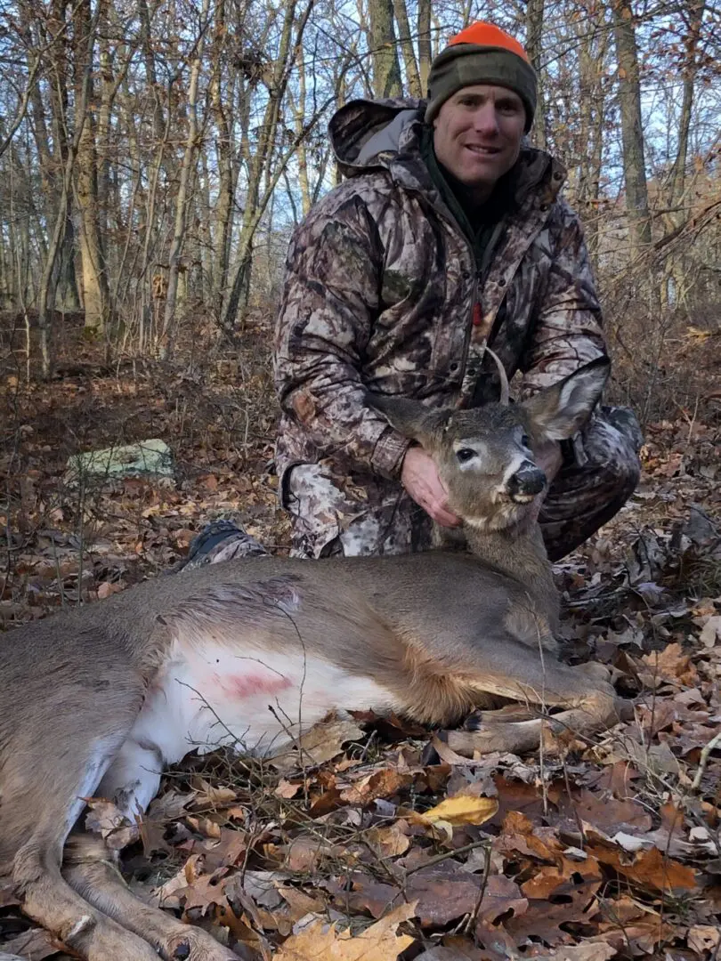 A Man Holding a Dead Deer From Deer Hunting
