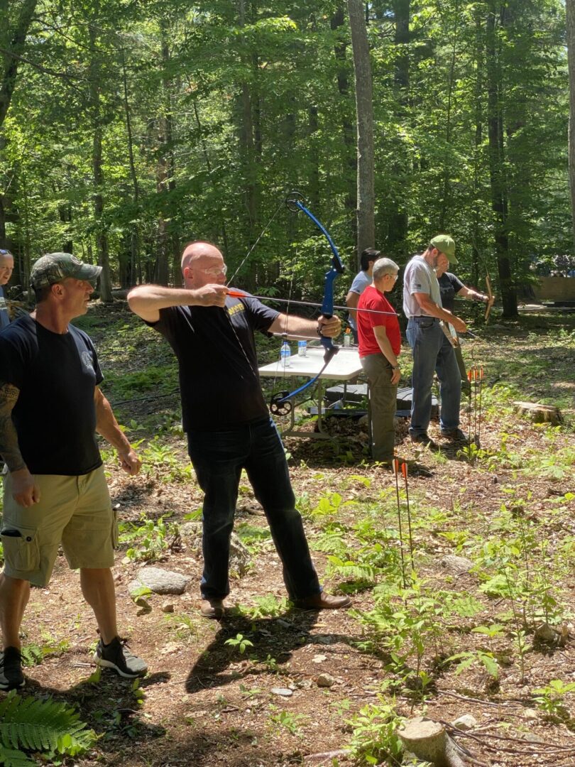A Man in Black Color Shirt and Pant Holding Bow and Arrow