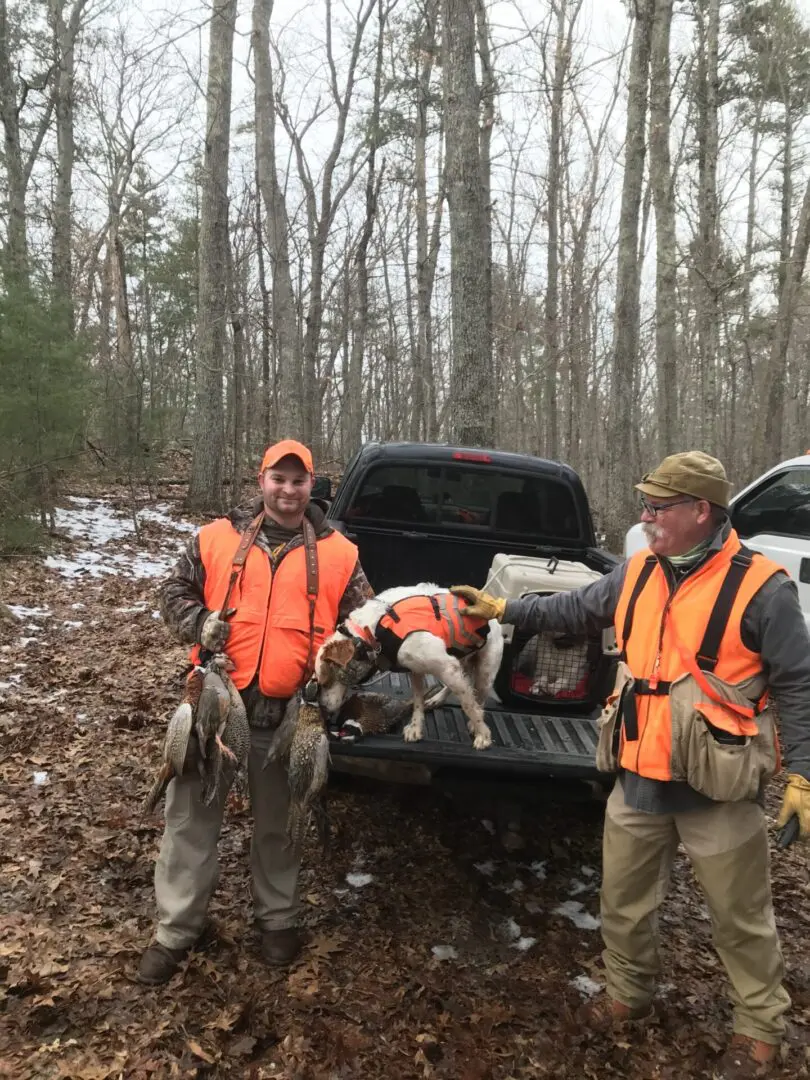 Two Men With a Dog Sniffing Hunt From Hunting