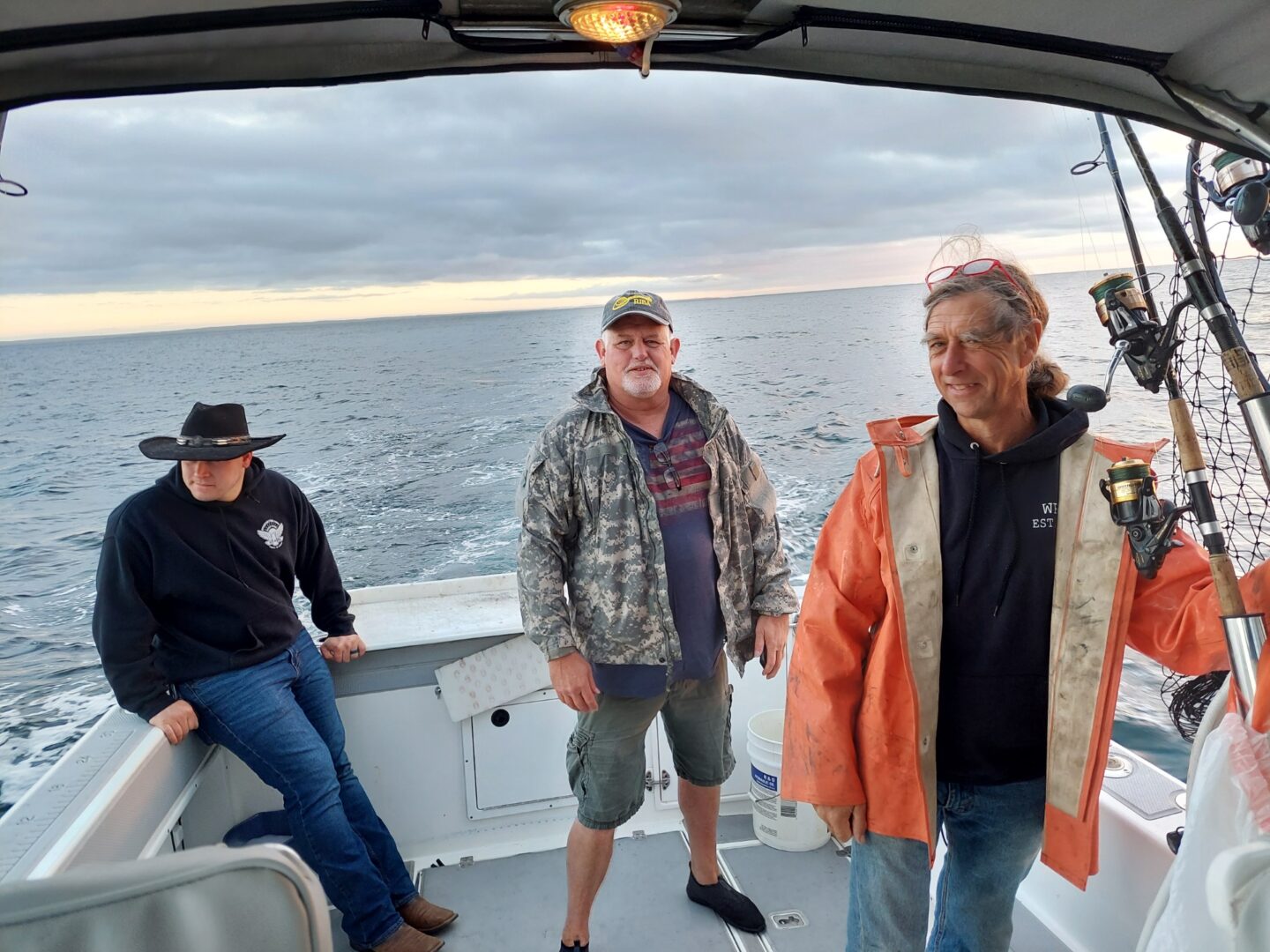 Three Men on a Boat in Water Going for Fishing