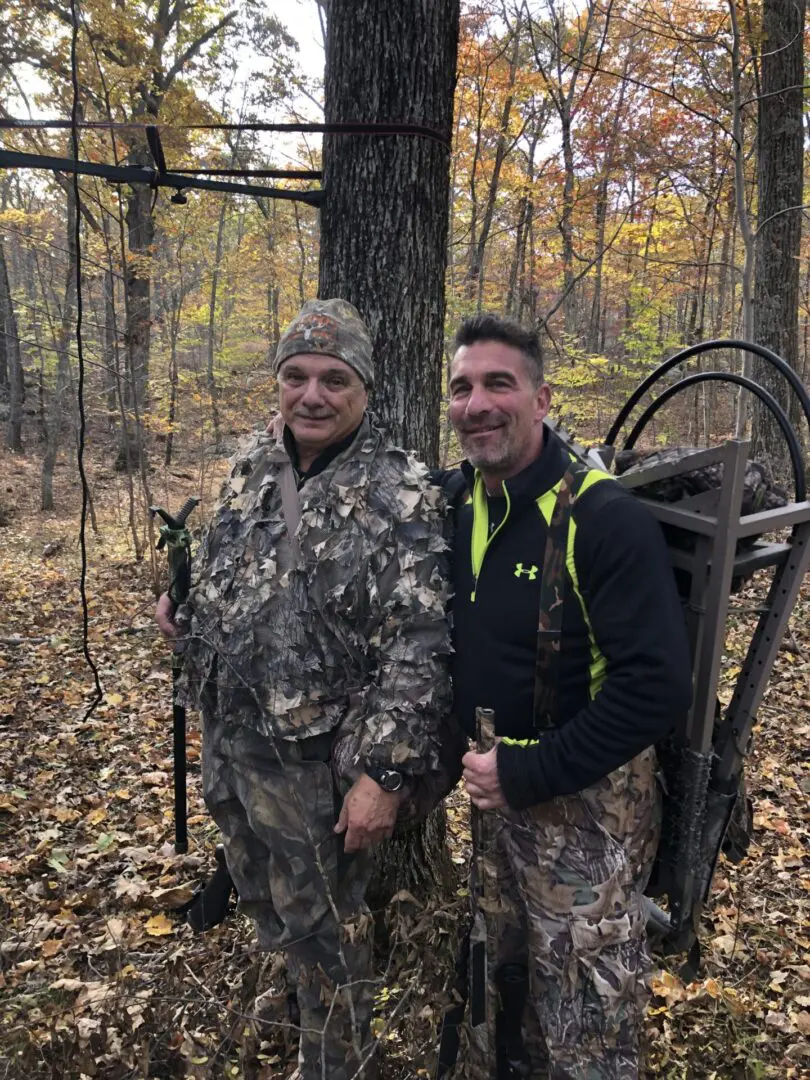 Two Men in Camouflage Gear in the Middle of the Woods