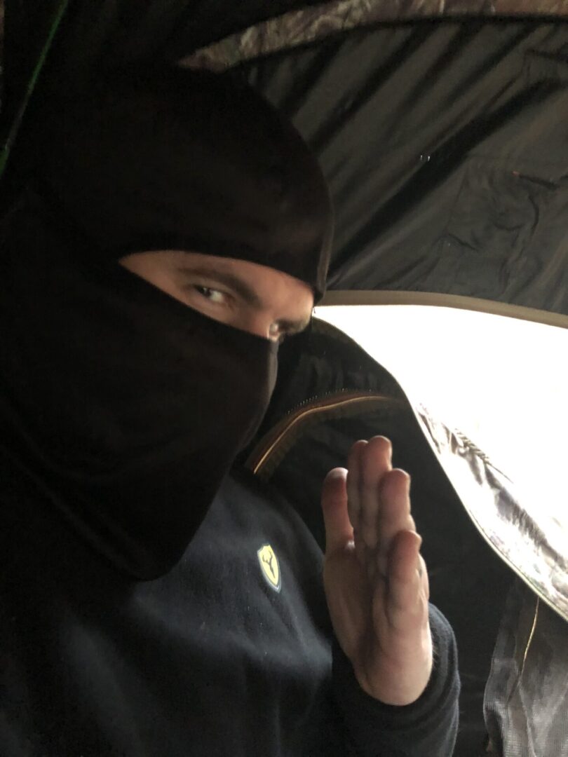 A Man in a Black Color Ski Mask and Black Top